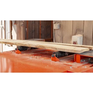 Wood-Mizer EG300 top rollers holding a board against the feed
