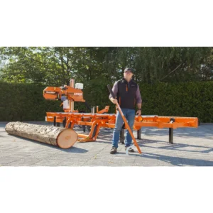 Operator holding a cant hook beside the Wood-Mizer LT20 Start and a log