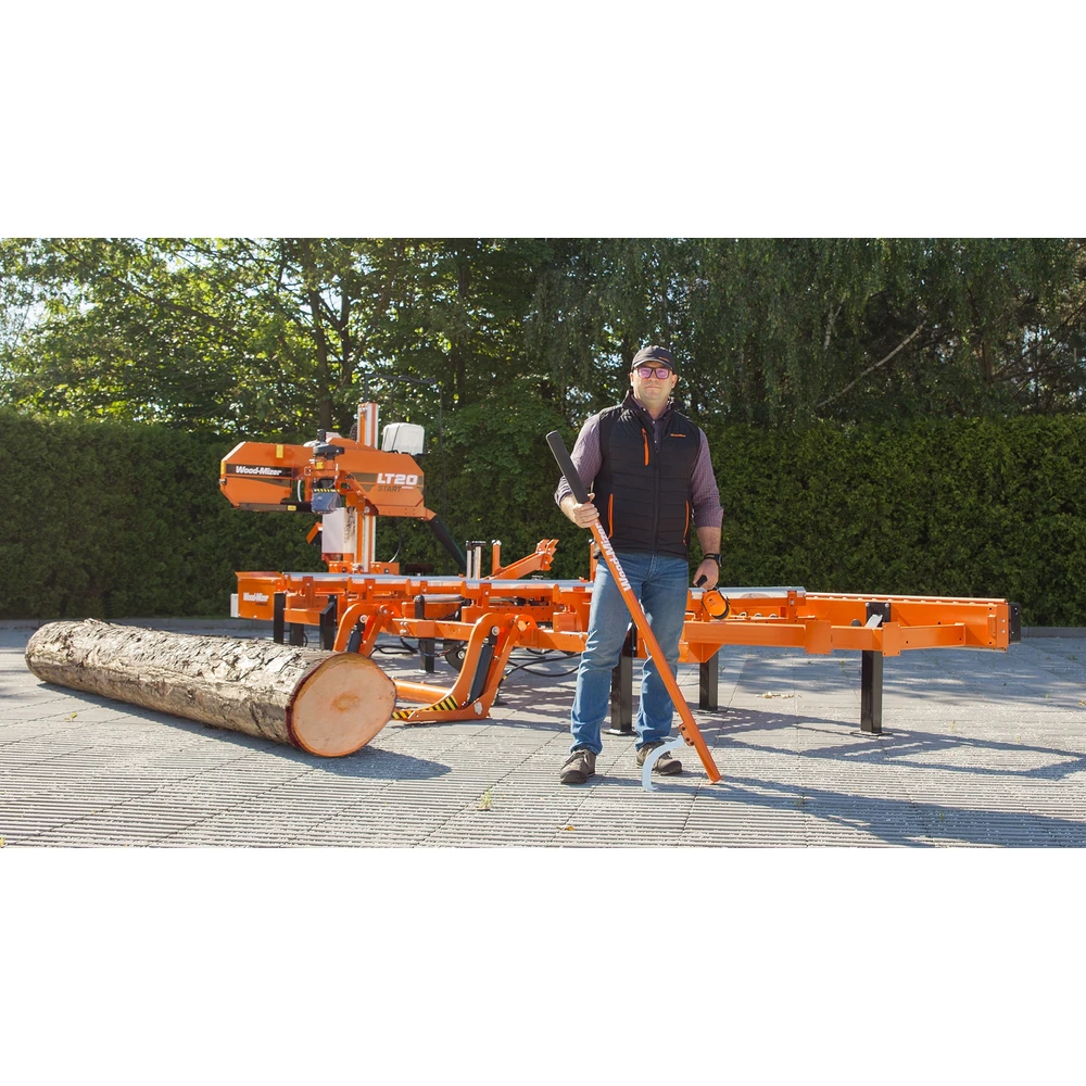 Operator holding a cant hook beside the Wood-Mizer LT20 Start and a log