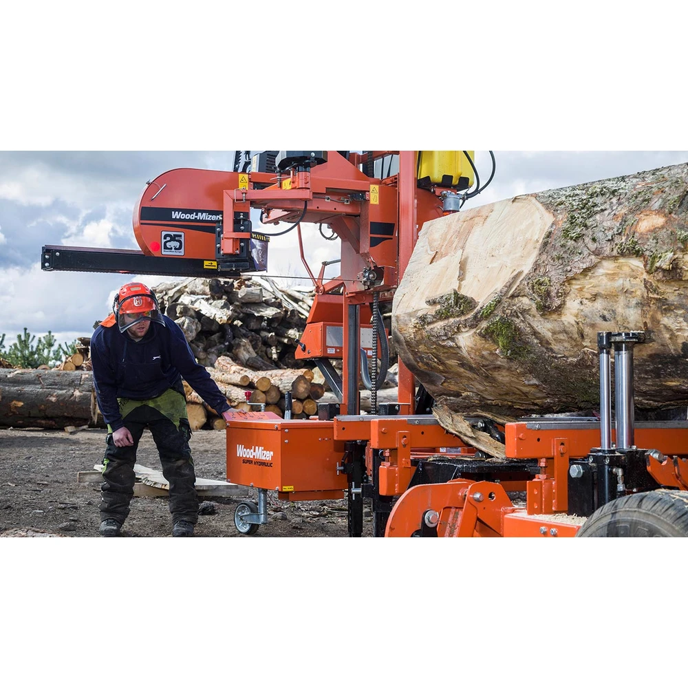 Operator beside a large log on the Wood-Mizer LT40 hydraulic sawmill