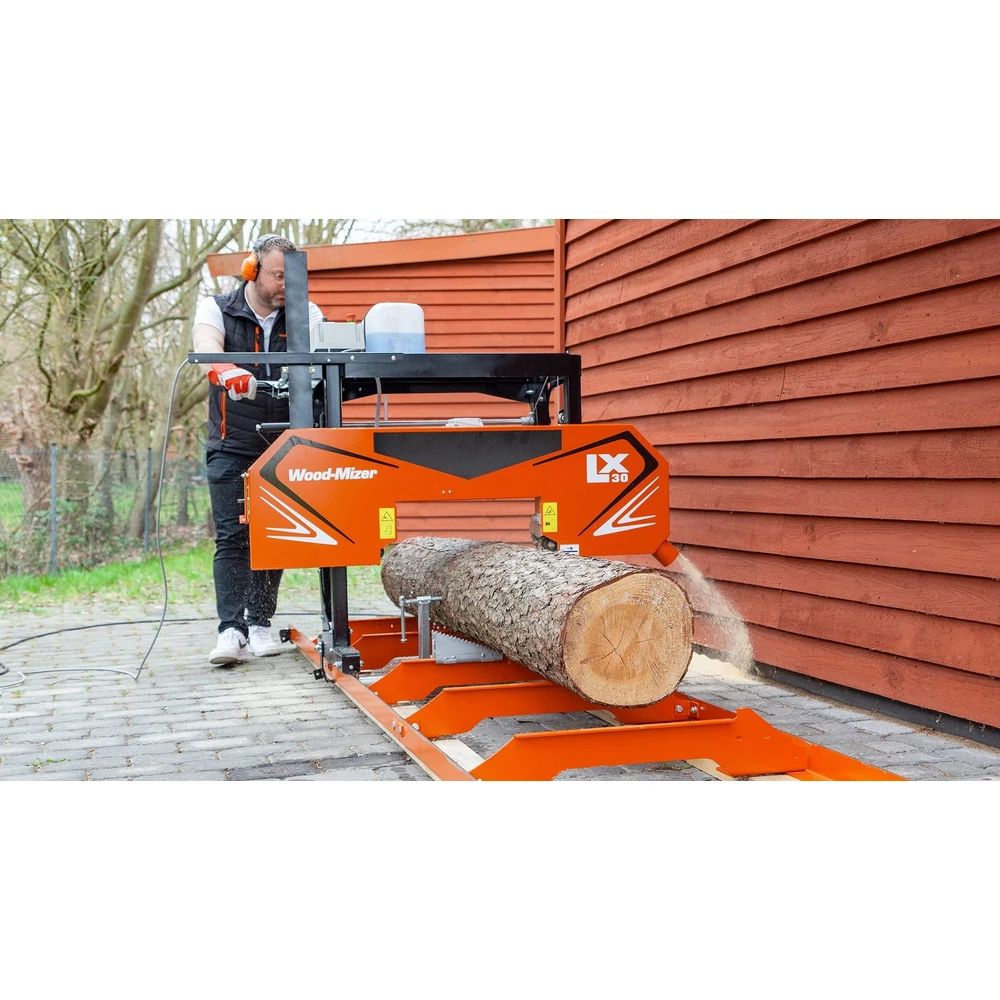 Operator cutting a log on the Wood-Mizer LX30 sawmill