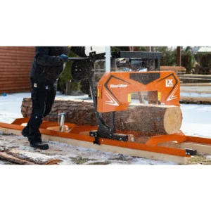 Operator sawing a log on the Wood-Mizer LX30 in the snow